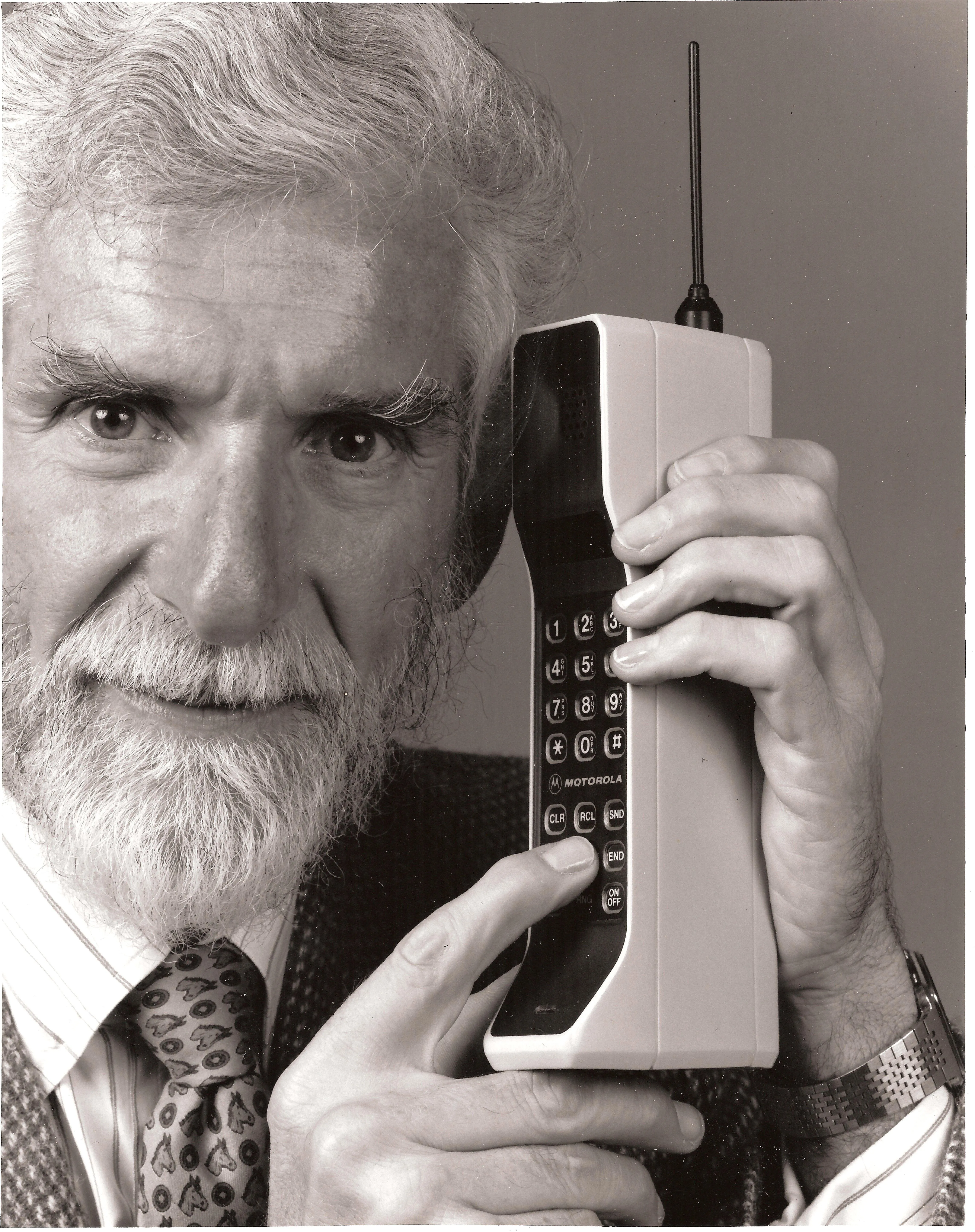 Martin Cooper holding a Motorola DynaTAC mobile phone